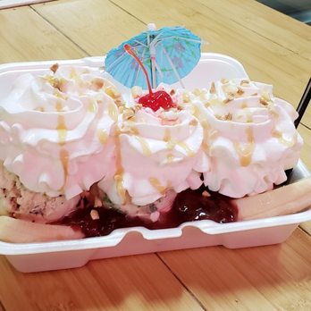 Strawberry banana split with whipped cream, cherry and umbrella