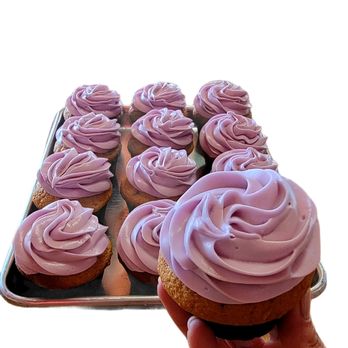 Tray of fresh-baked cupcakes with purple frosting